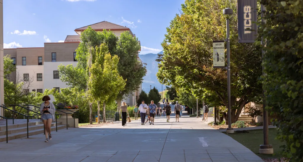 students walking together on campus side walk